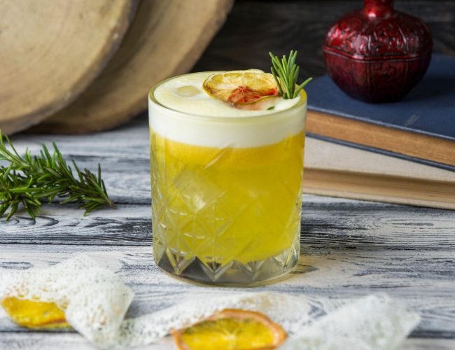 lemon-drink-garnished-with-dried-lemon-slice-rosemarine-crystal-glass_140725-790